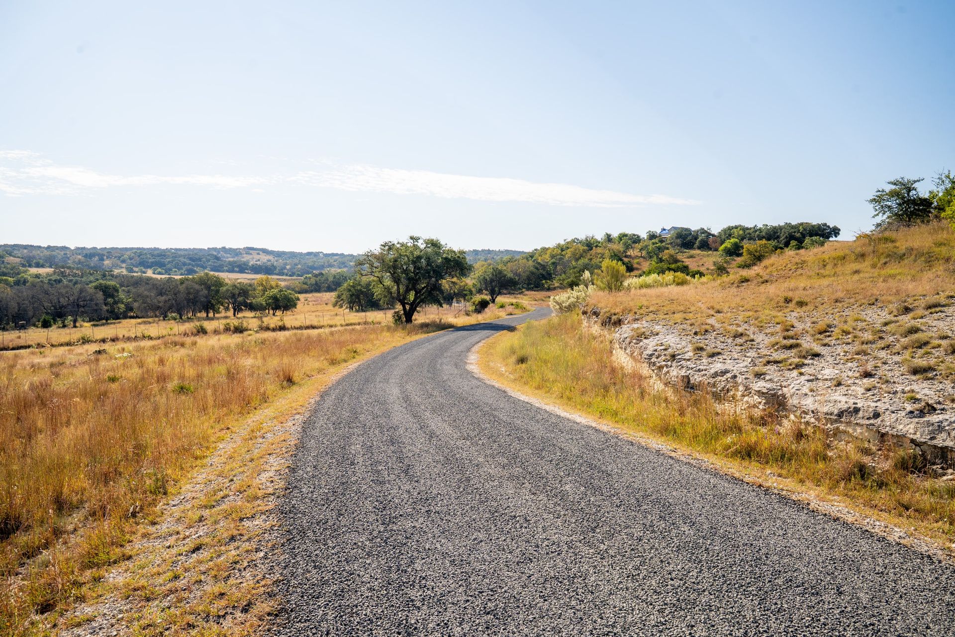 Finished aggregate road curving along a rocky hillside