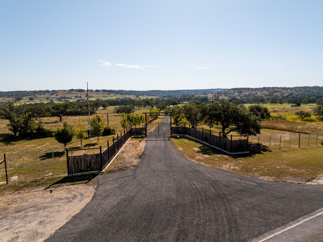 Rural road passing through a gated property entrance