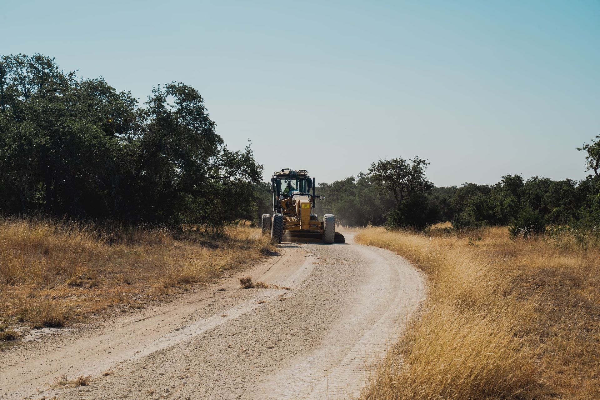 Motor grader shaping a rural road base