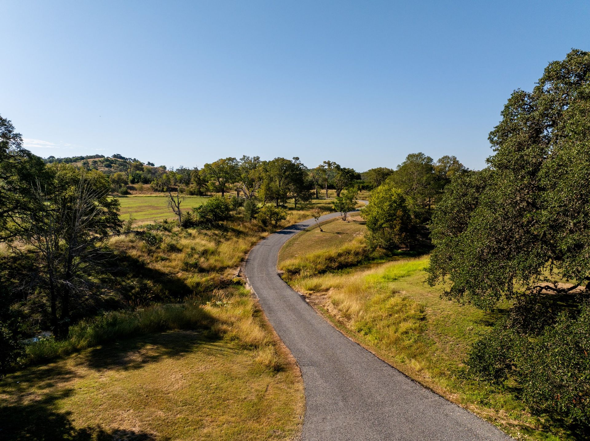 Aerial view of a winding road through rural acreage